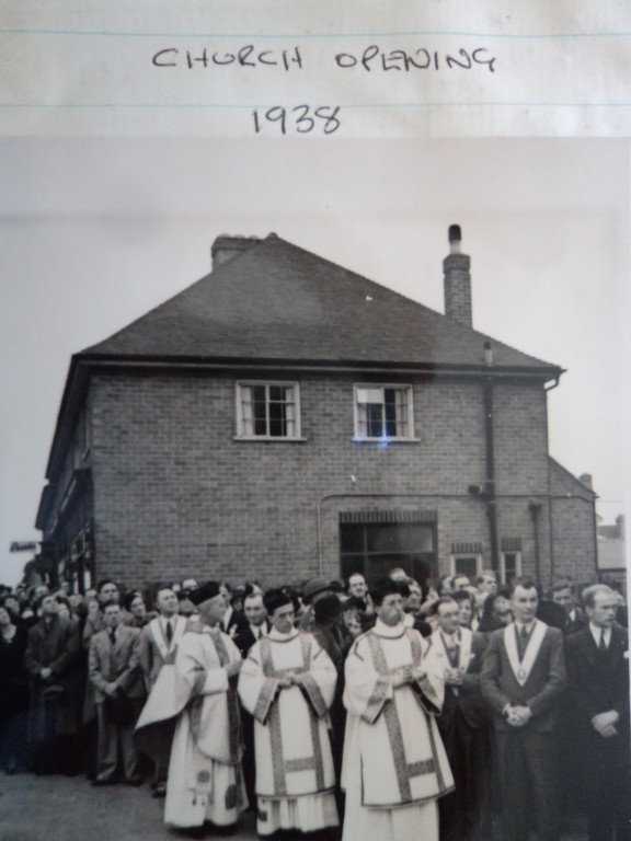 A group gathered outside an early church building