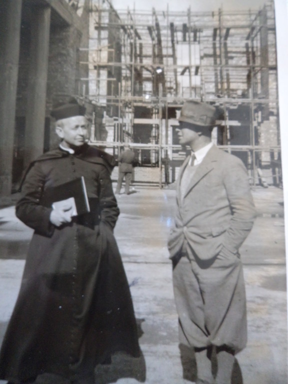 A priest and another man standing outdoors