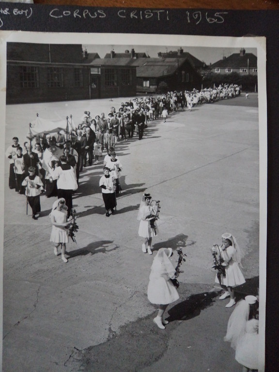 An archival newspaper photograph of a street procession
